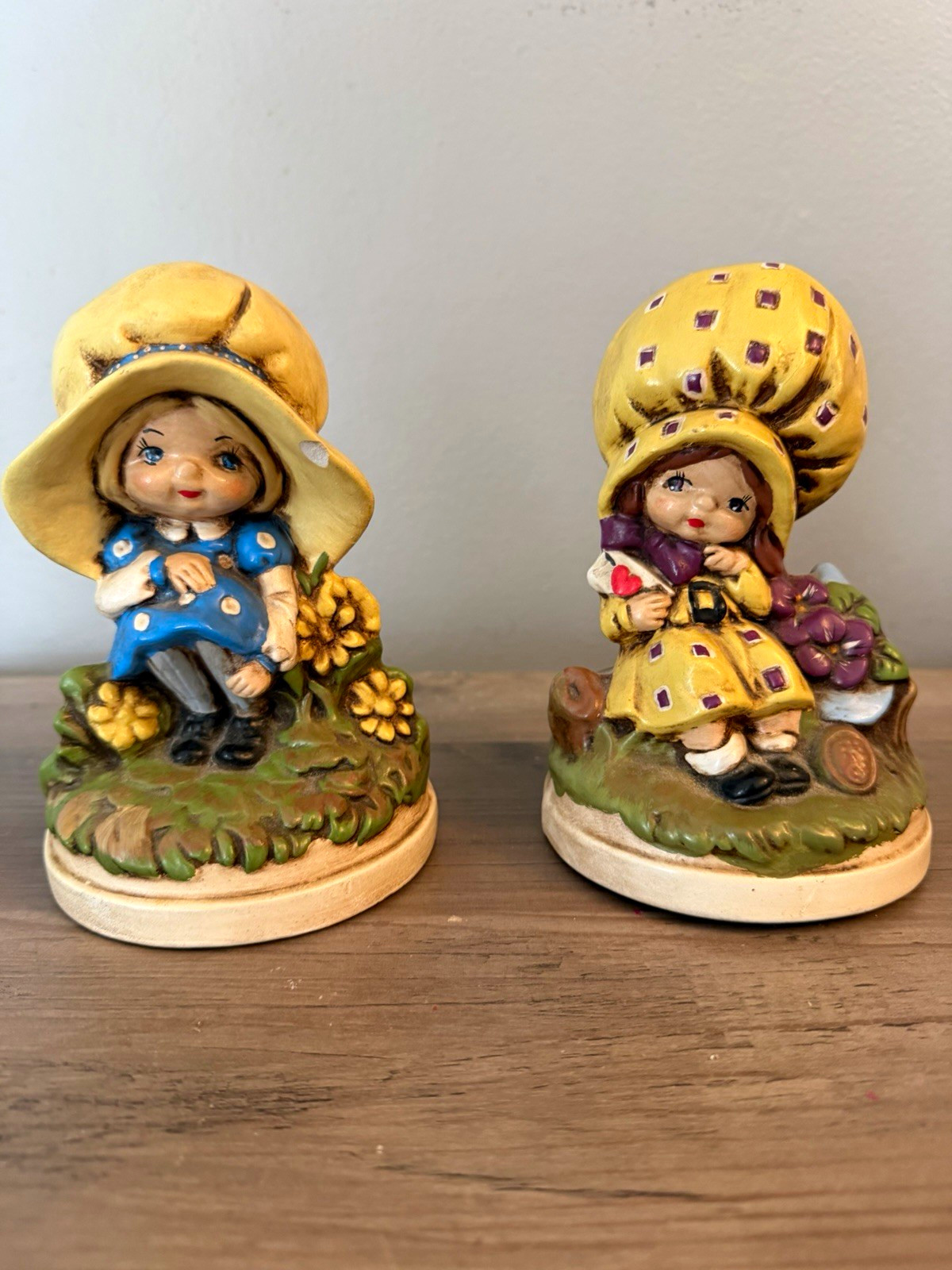Vintage 1970s ceramic figurines of two girls in yellow hats with blue polka dots Vintage 1970s ceramic figurines of two girls in yellow hats with blue polka dots