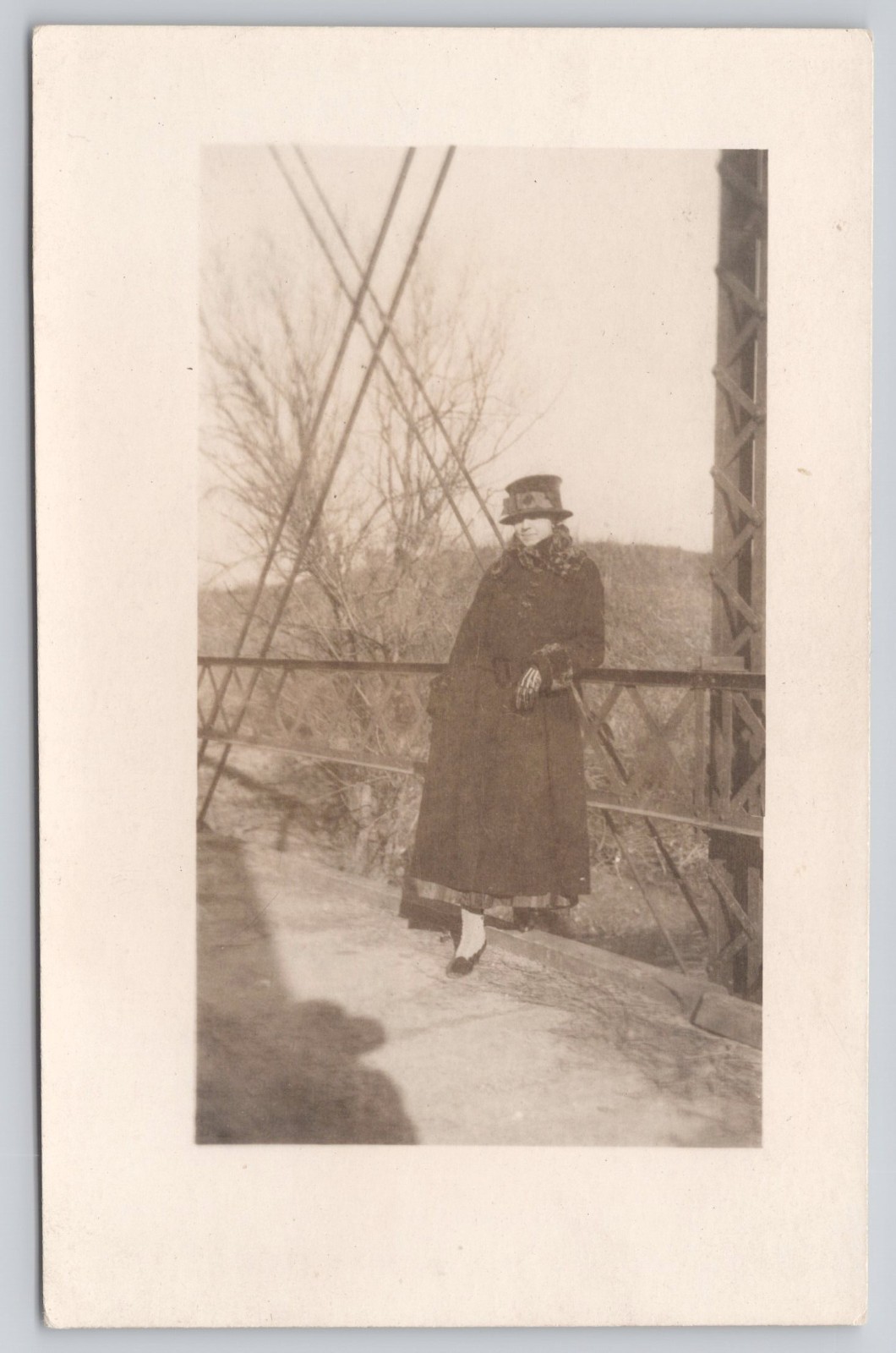 RPPC Woman Decorative Hat Coat Leaning Against Iron Bridge Real Photo Postcard