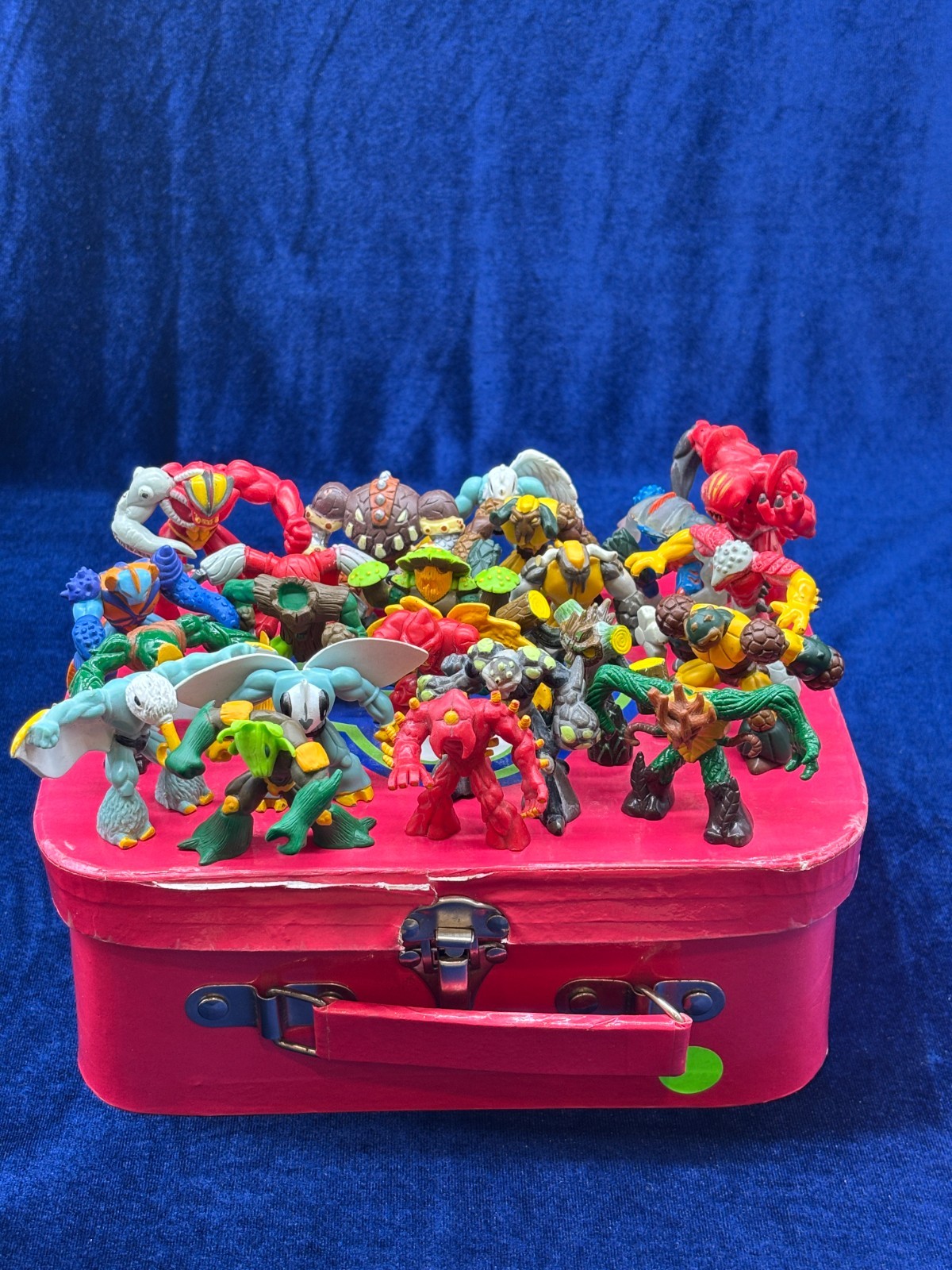 A Collection Of Various Gormiti Figurines Packed In A Pink Suitcase A Collection Of Various Gormiti Figurines Packed In A Pink Suitcase