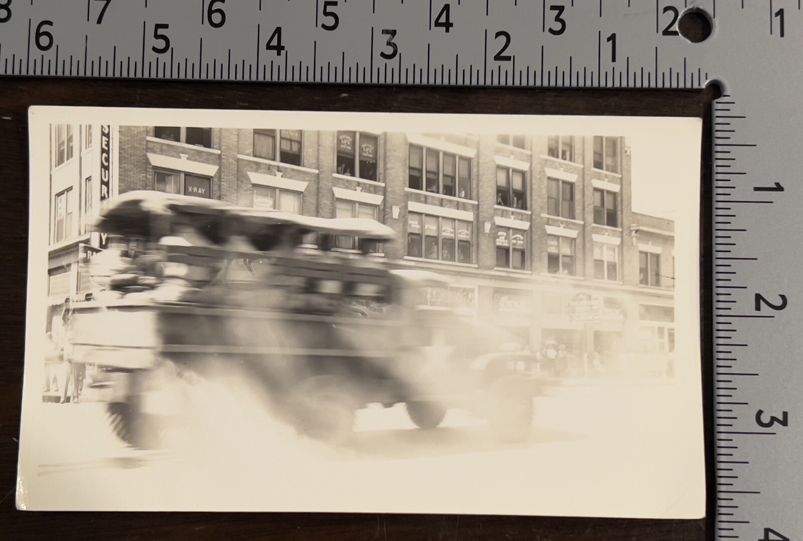 BLURRED MIILTARY ARMY VEHICLE TRANSPORTING SOLDIERS B&W PHOTOGRAPH