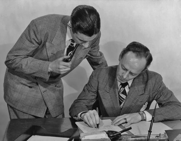 Two men checking a document in the office circa 1940's Historic Old Photo Two men checking a document in the office circa 1940's Historic Old Photo