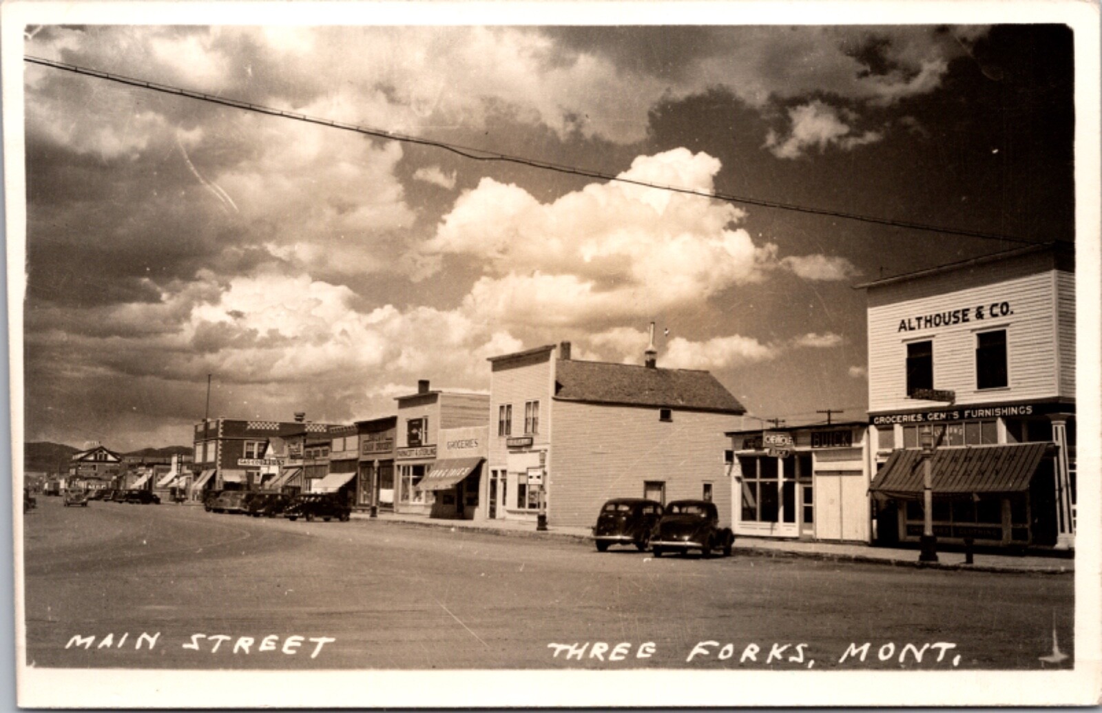 Real Photo Postcard Automobiles Along Main Street in Three Forks, Montana Real Photo Postcard Automobiles Along Main Street in Three Forks, Montana