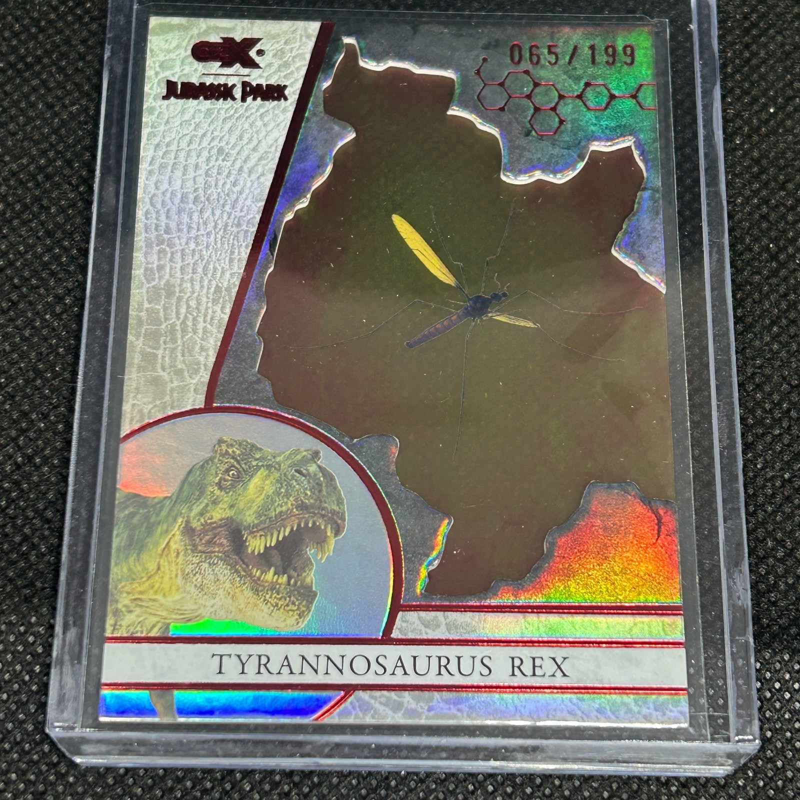 2026 JURASSIC PARK CRYPTOZOIC CZX T-REX AMBER INSERT #A8 RED PARALLEL #d 065/199 2026 JURASSIC PARK CRYPTOZOIC CZX T-REX AMBER INSERT #A8 RED PARALLEL #d 065/199
