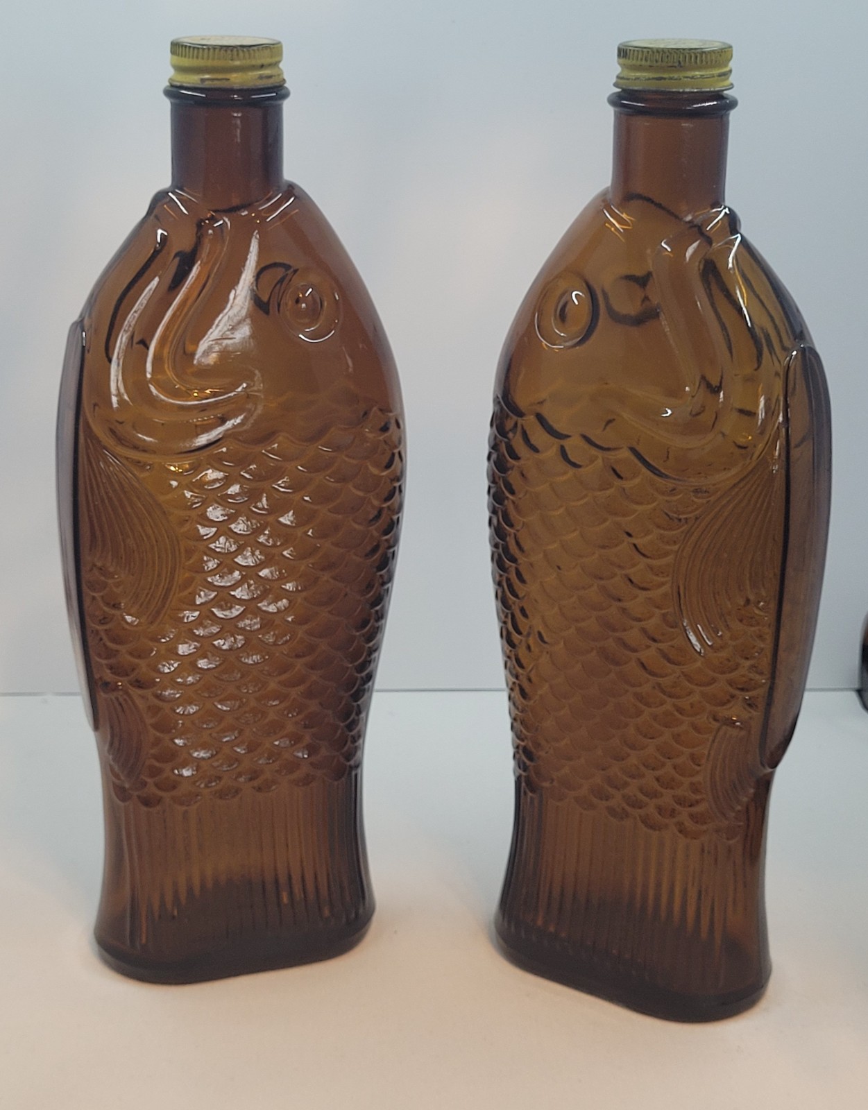 Pair of Vintage 1930s Fish shaped Amber Glass Cod Liver Oil bottle original cap Pair of Vintage 1930s Fish shaped Amber Glass Cod Liver Oil bottle original cap