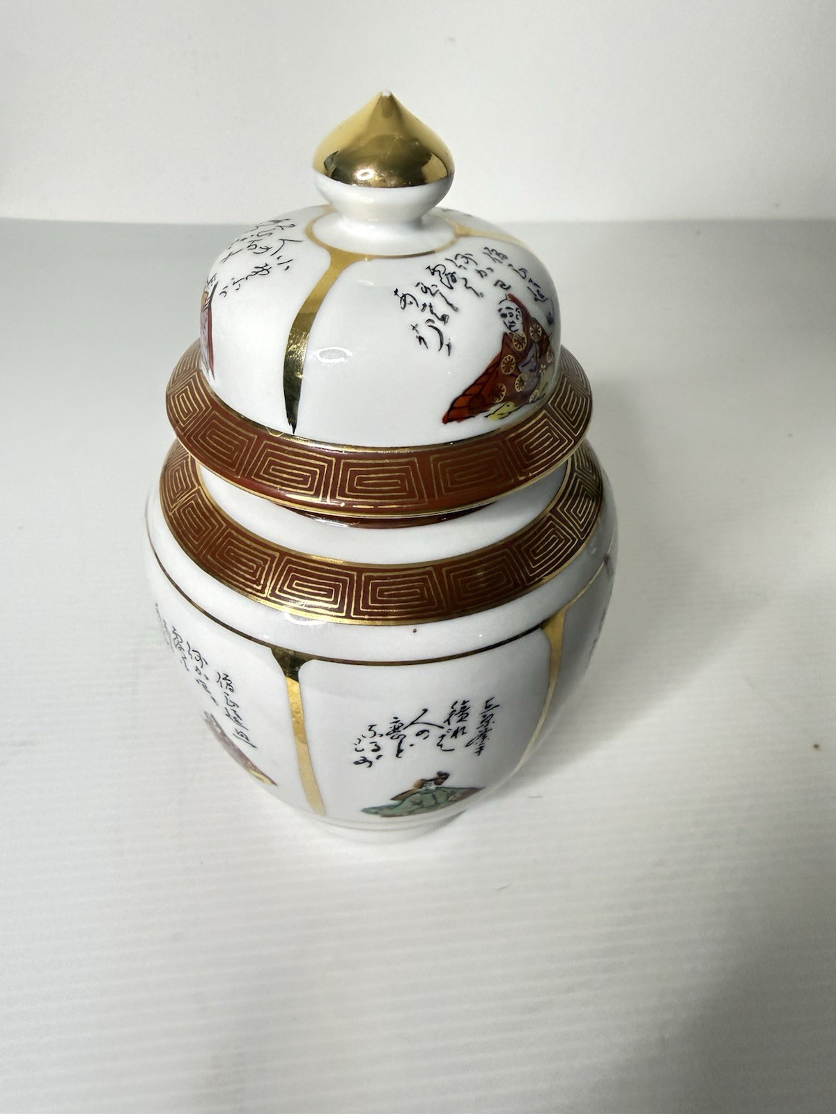 Japanese Porcelain Lidded Jar with Kintsugi-Style Decorative Accents Japanese Porcelain Lidded Jar with Kintsugi-Style Decorative Accents