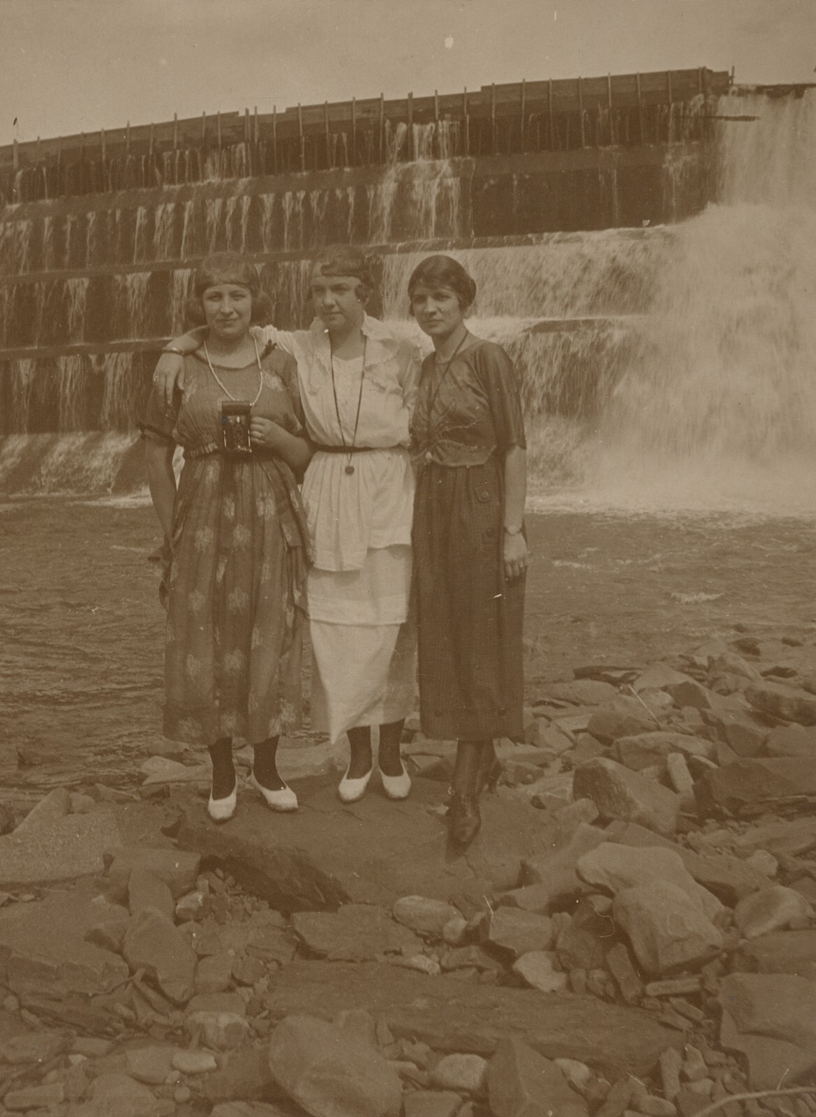 c. 1920\'s Three Flapper Girls with Camera in Front of Dam Photograph c. 1920\'s Three Flapper Girls with Camera in Front of Dam Photograph