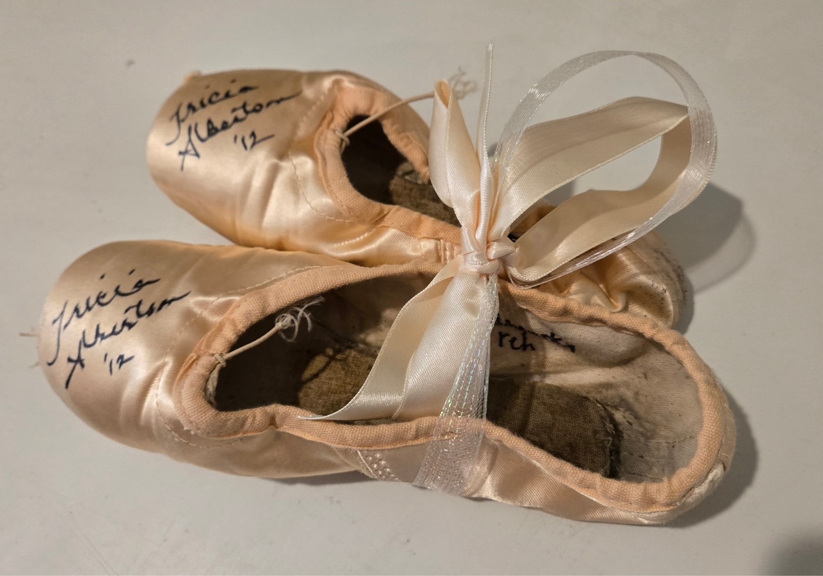 Performance worn ballet slippers signed by Prima Ballerina, Tricia Albertson Performance worn ballet slippers signed by Prima Ballerina, Tricia Albertson