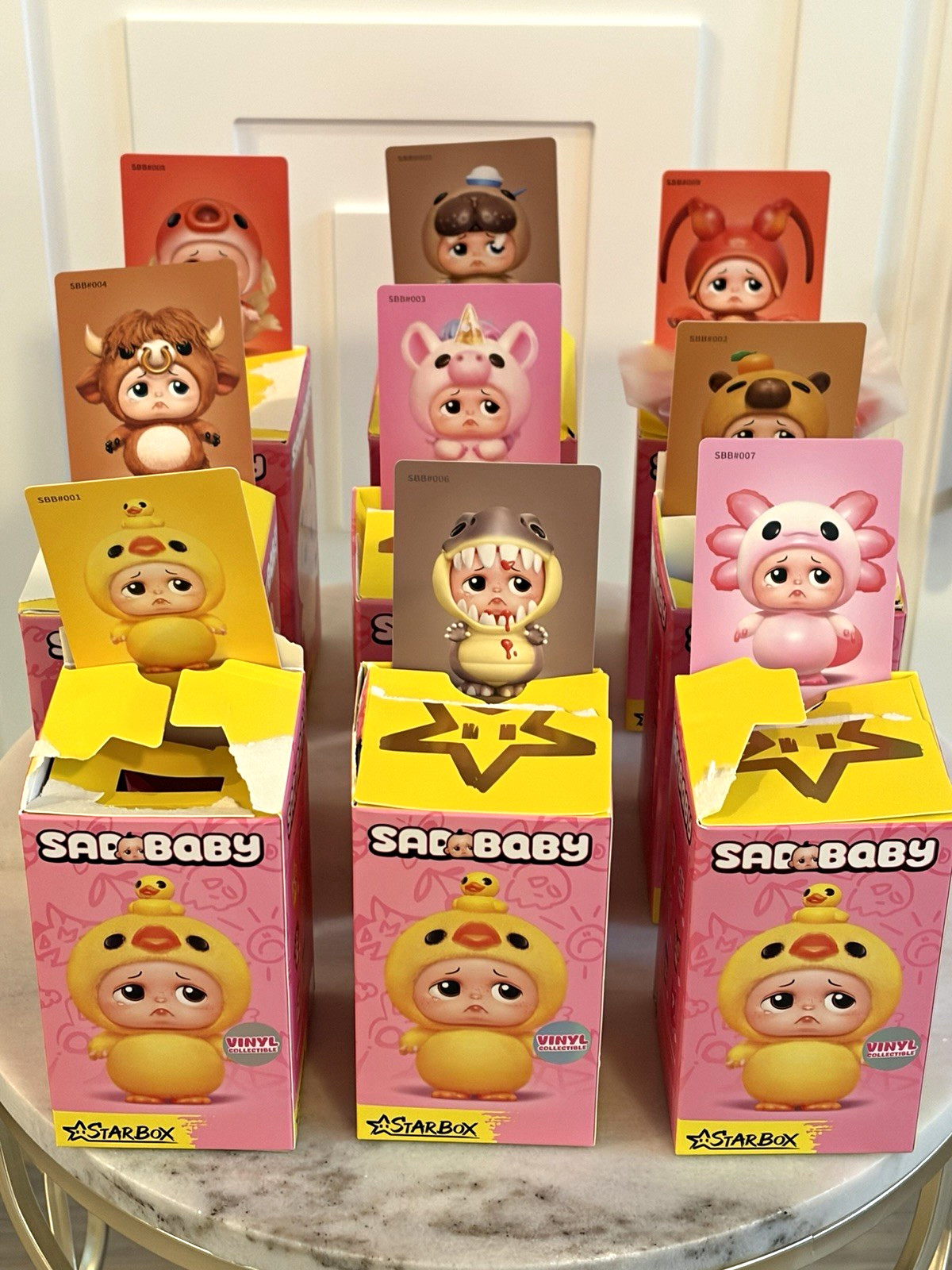 StarBox SADBABY Vinyl Collectible Figure Lot of 9 - Complete Set (Open Box) StarBox SADBABY Vinyl Collectible Figure Lot of 9 - Complete Set (Open Box)