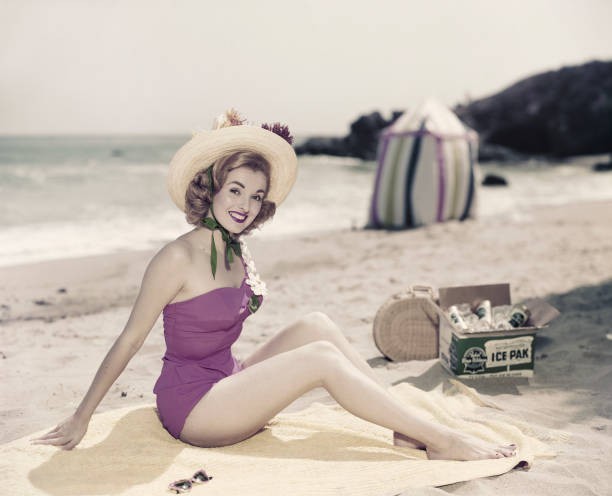 Young woman in swimwear at beach portrait smiling Historic 1960s Old Photo Young woman in swimwear at beach portrait smiling Historic 1960s Old Photo