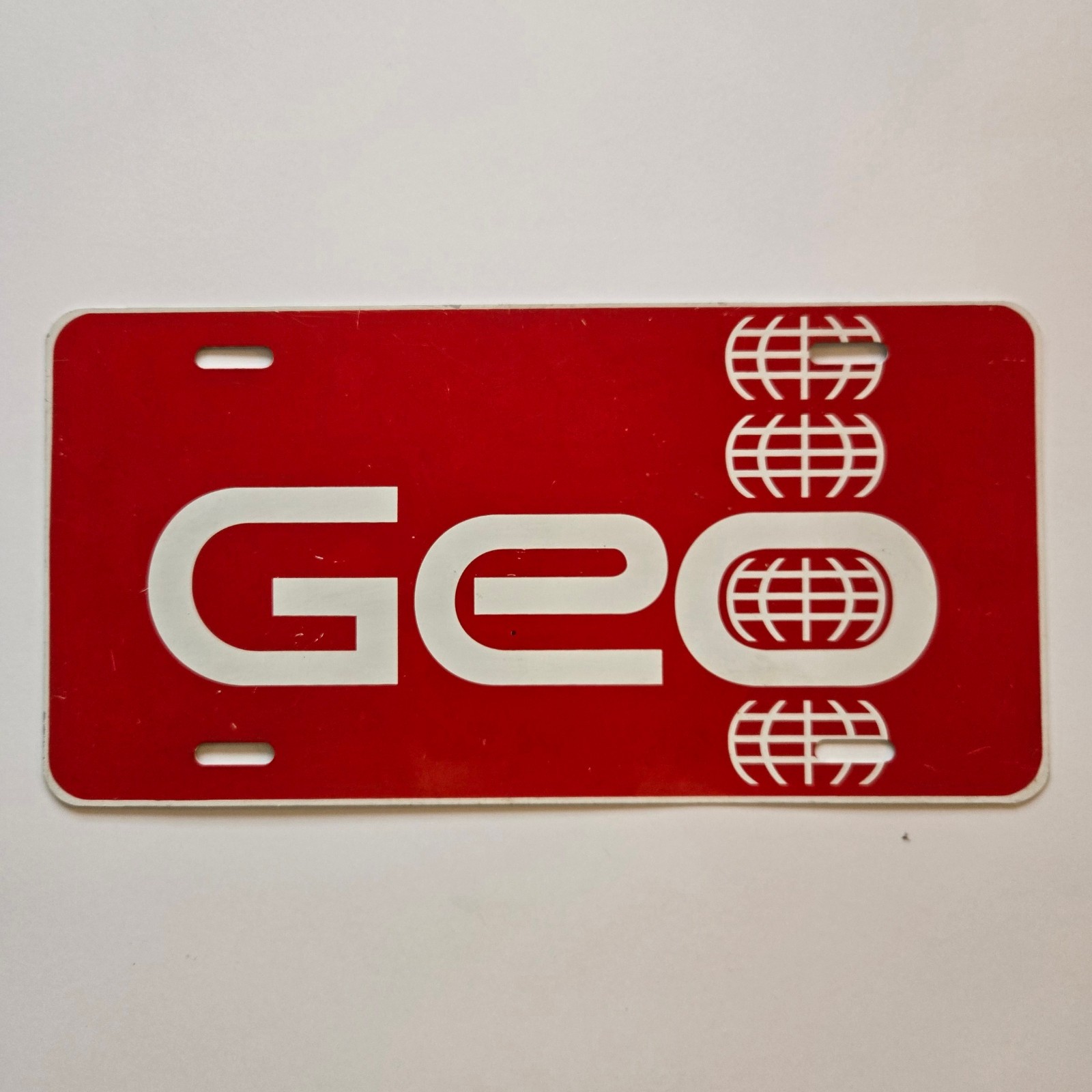 Vintage GEO License Dealer Plate Booster Metal - Metro Storm Prism Tracker