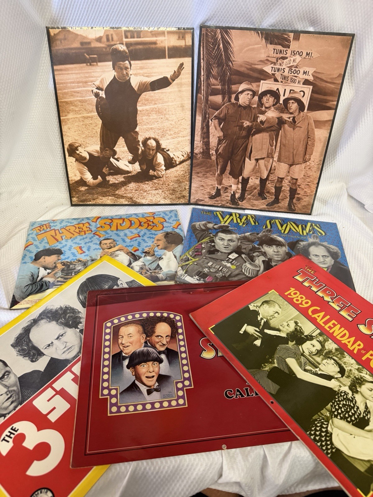 The Three Stooges Lot Of (5) Calendars And (2) Hardbacked Prints The Three Stooges Lot Of (5) Calendars And (2) Hardbacked Prints