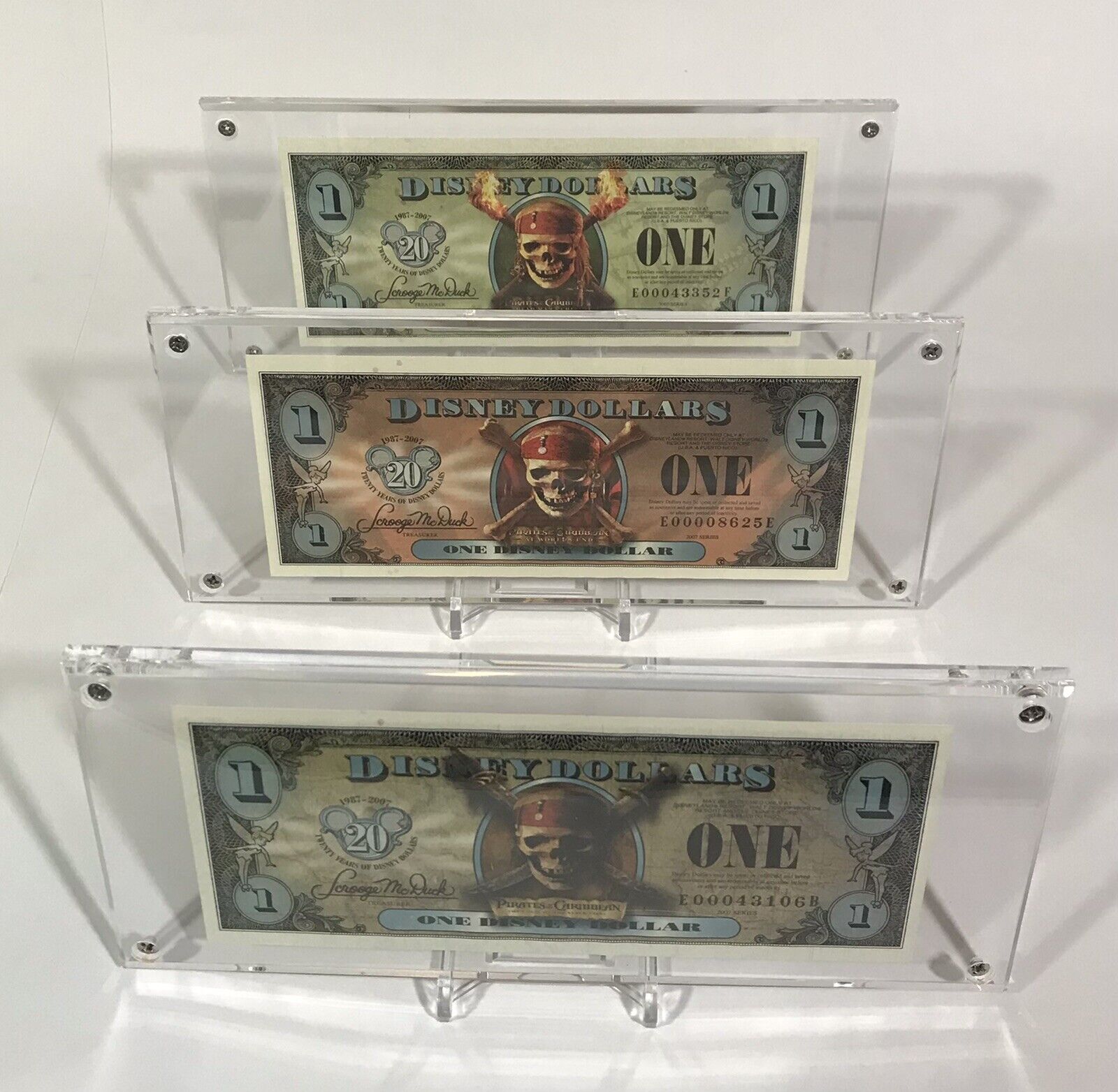 2007 Disney Dollars $1 PIRATES OF THE CARIBBEAN SET OF 3 in Display Holders