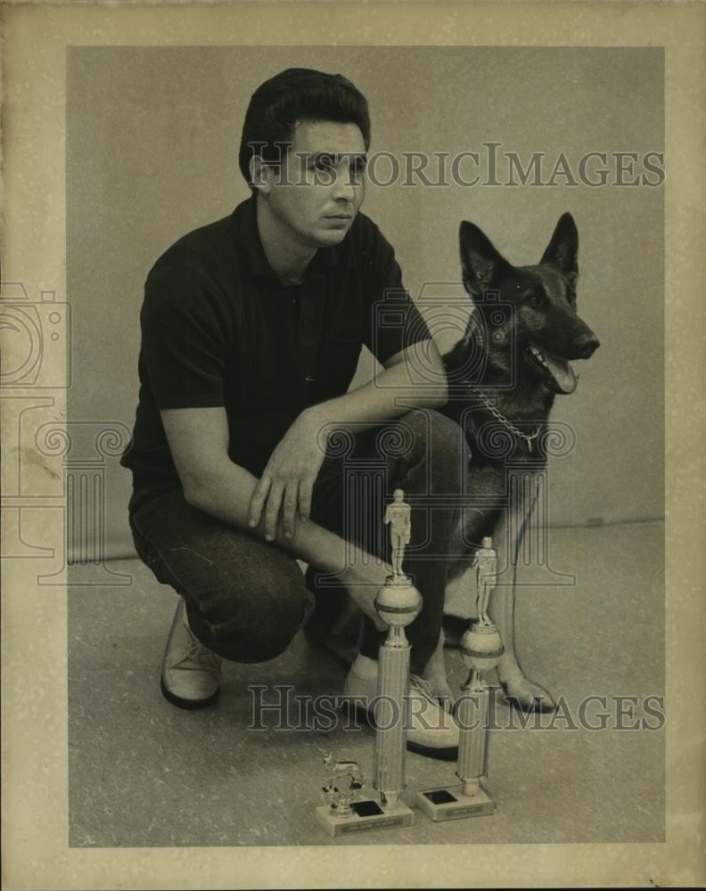 1968 Press Photo Manuel Garza poses with his German shepherd and trophies