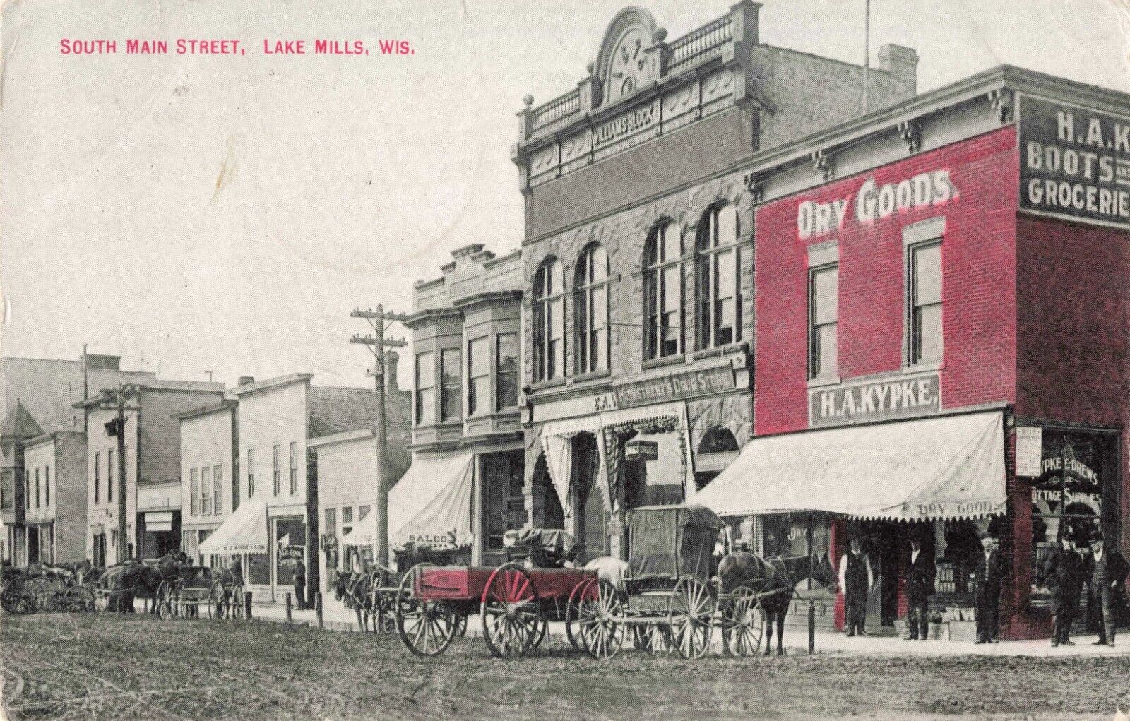 South Main Street Lake Mills Wisconsin WI Dry Goods Drug Store 1910 Postcard