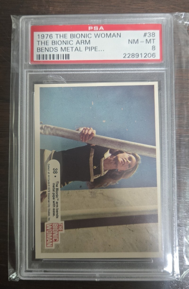 1976 Donruss The Bionic Woman The Bionic Arm Bends Metal Pipe #38 PSA 8 1976 Donruss The Bionic Woman The Bionic Arm Bends Metal Pipe #38 PSA 8