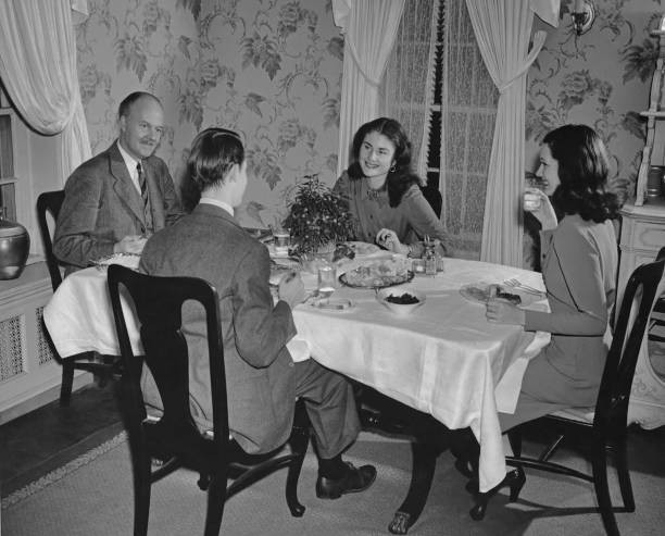 Two men and two women talking over dinner circa 1940 Historic Old Photo Two men and two women talking over dinner circa 1940 Historic Old Photo
