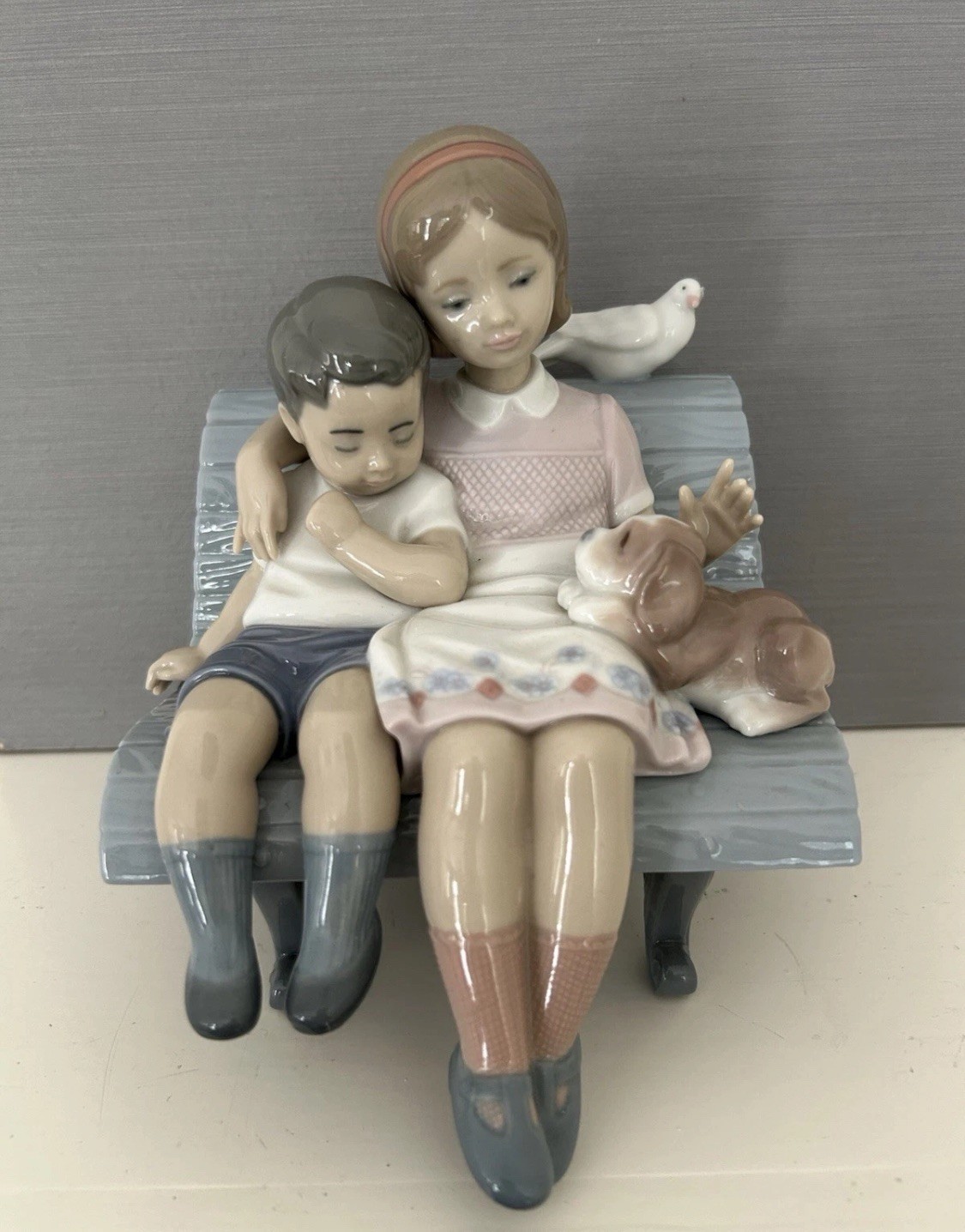 Lladro “Brother and Sister on a Bench with Dog and Bird” Figurine (#6446) Lladro “Brother and Sister on a Bench with Dog and Bird” Figurine (#6446)