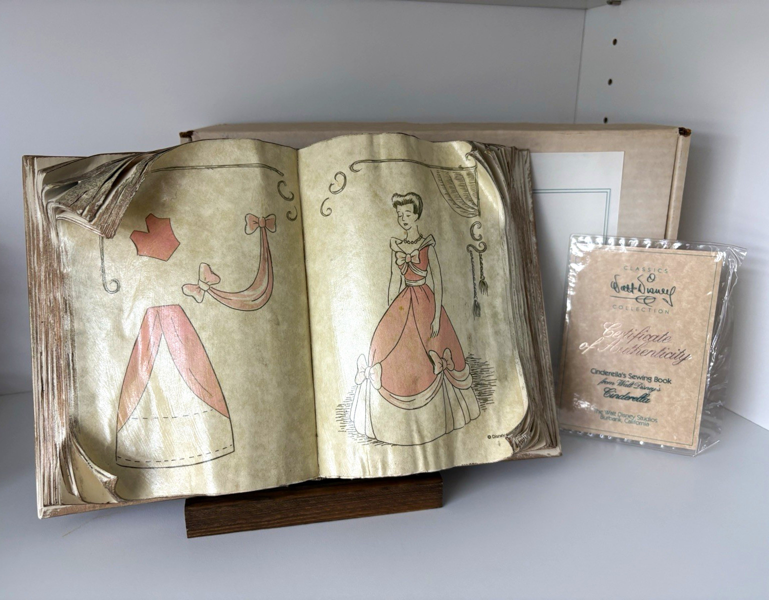 WDCC Cinderella's Sewing Book w/ wood stand and COA WDCC Cinderella's Sewing Book w/ wood stand and COA