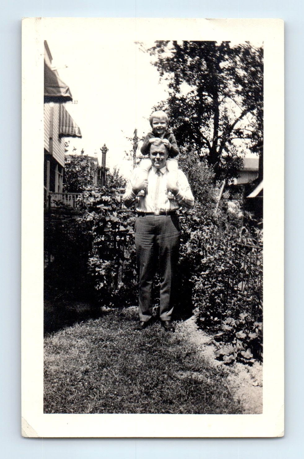 Old Vintage Photo BOY SITTING ON SHOULDERS OF MAN OUTSIDE HOUSE IN YARD Old Vintage Photo BOY SITTING ON SHOULDERS OF MAN OUTSIDE HOUSE IN YARD