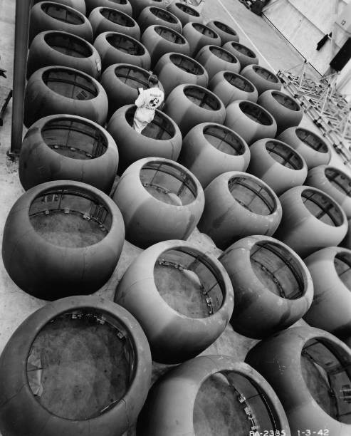 High angle view aviation engineer standing among engine cowlings a- Old Photo High angle view aviation engineer standing among engine cowlings a- Old Photo