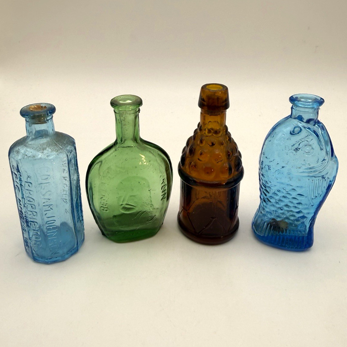 4 vintage mini glass bottles. Wheaton style 3” Taiwan Fish, drum, Ben Franklin 4 vintage mini glass bottles. Wheaton style 3” Taiwan Fish, drum, Ben Franklin