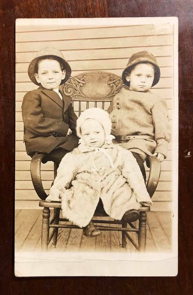 Vintage RPPC Real Photo Postcard - Three children posing on chair c.1900s-1910s