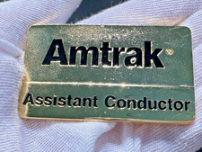AMTRAK ASSISTANT CONDUCTOR SHINY GOLD TONE UNIFORM BADGE PIN H723 picture