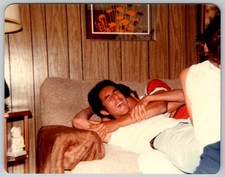 Vtg Color Snapshot Laughing Young Man Wrestling Couch Wood Paneling 1970s picture