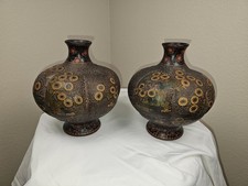Matching pair of vintage Asian ceramic vases featuring rounded bodies picture