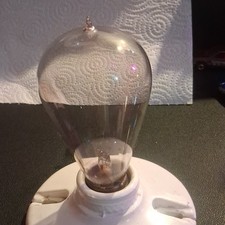 vintage 1890's hand blown working light bulb. on a vintage porcelain socket. picture