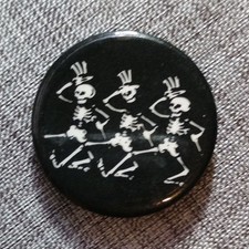 Vintage Grateful Dead pinback button. Black, with dancing skeletons. 1-1/4