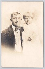 RPPC Portrait of Man Blond Hair Bowtie Holding Young Daughter 1918-1930 Postcard picture