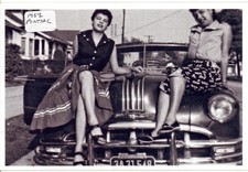 Two Ladies Sitting on a 1952 Pontiac Photo picture