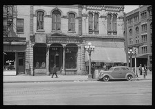 Photo:Downtown Street 1930s Storefronts Hotel Automobiles Pedestrians picture