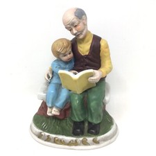 Grandfather Reading Book to Grandson Child Sitting on Bench Ceramic Figurine picture