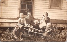 Antique RPPC Real Photo Postcard - 6 Children with Wheelbarrow in Front of House picture