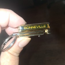 PONTIAC BONNEVILLE SPRING KEYCHAIN FOB MAIL DROP TAG GOLD TONE BIRMINGHAM MI... picture