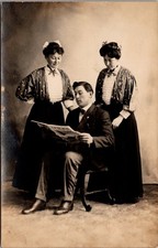 RPPC Man Reading Newspaper Two Women Studio Portrait Vintage Postcard 4P24-30 picture