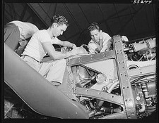 Final installations are made on a North American P-51 Mustang fighter on the picture