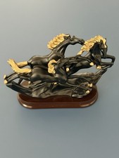 Elegant Black & Gold Running Horses Sculpture on Plastic Base picture