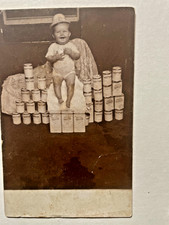 RPPC Scarce View of 8 month old Baby Sitting on Canned-Goods c.1910 picture