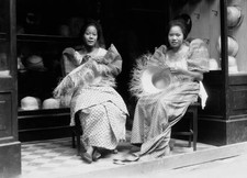 Two ladies making raffia straw hats street outside a hat shop they- Old Photo picture