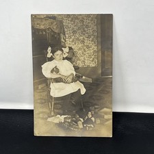 Vintage RPPC Young Girl Holding Cat in rocking chair toys dolls blocks Postcard picture