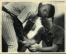 1989 Press Photo Brewer's Gary Sheffield is examined by trainer John Adam. picture