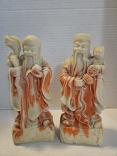 a pair of Chinese carved stone or resin figures depicting the Sanxing (the three picture