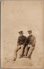 RPPC 2 Soldiers Outdoor Sitting On A Rock, Real Photo Postcard picture