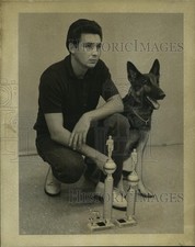 1968 Press Photo Manuel Garza poses with his German shepherd and trophies picture