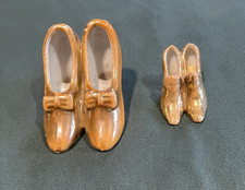 Lot of two vintage gold toned shoes with JAP logo on the bottom of larger pair. picture