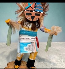 Handcrafted wooden Kachina doll with feathers and fabric, signed by maker picture